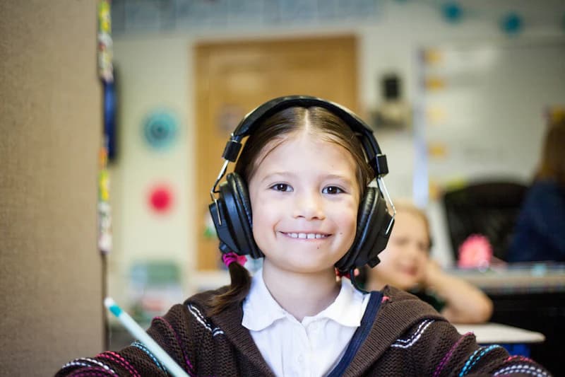 Smiling girl wearing big headphones